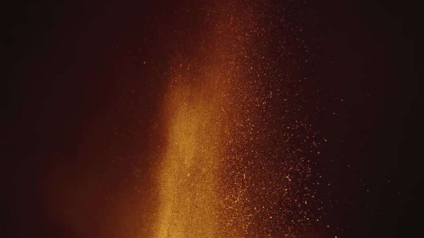 An eruption with lava and many incandescent sparks going upward