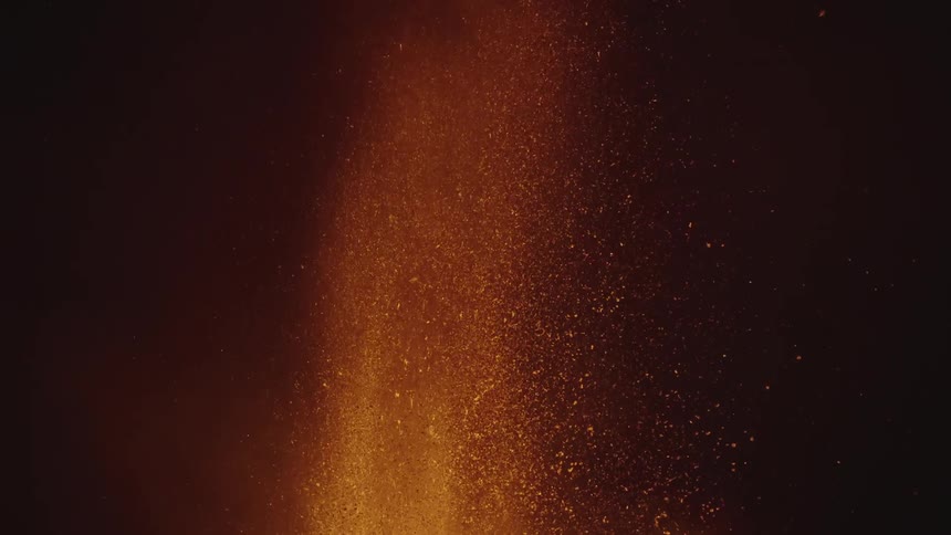 A volcanic eruption with bright lava and ash against a dark background