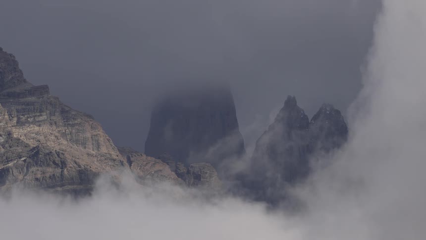 A mountainous region with dense white fog over the environment