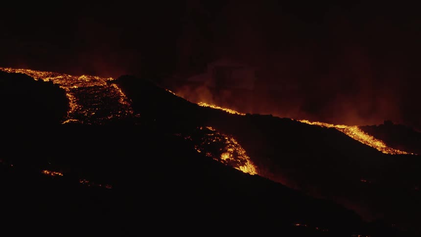 Lava slowly rolling down and destroying everything in its path