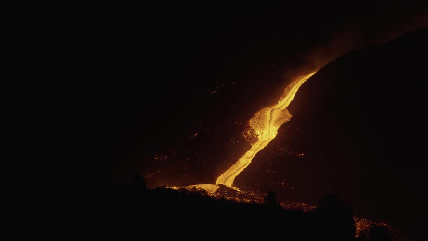 Aerial of a volcanic lava river at night