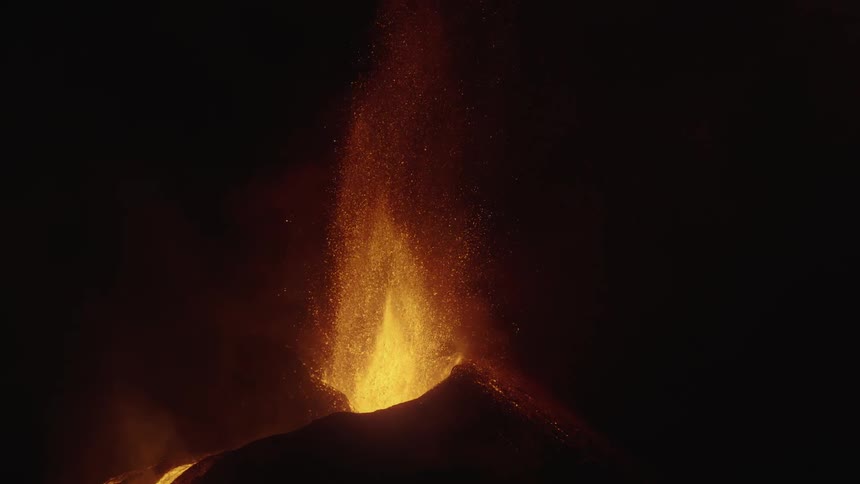 An eruption of a volcano with a lot of lava being thrown upwards