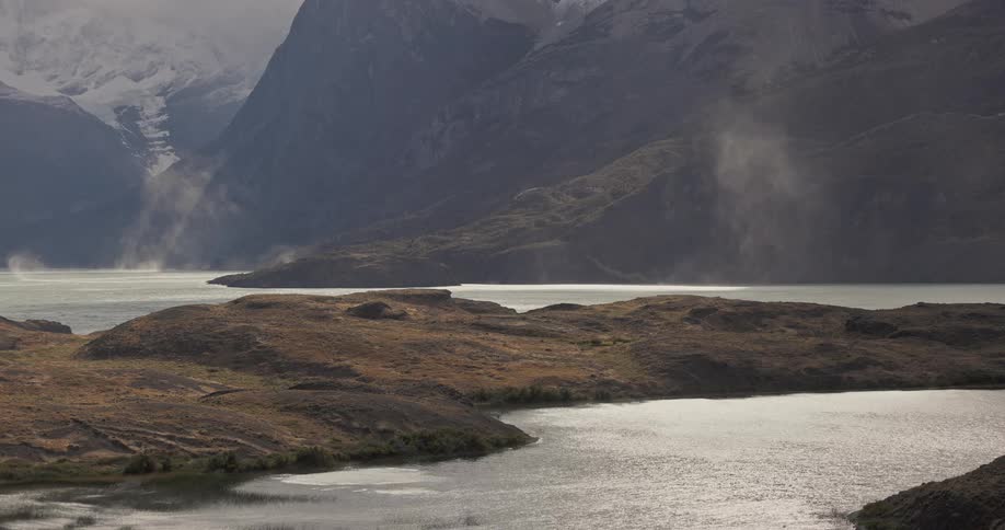 strong winds moving gusts of spray over a mountain lake