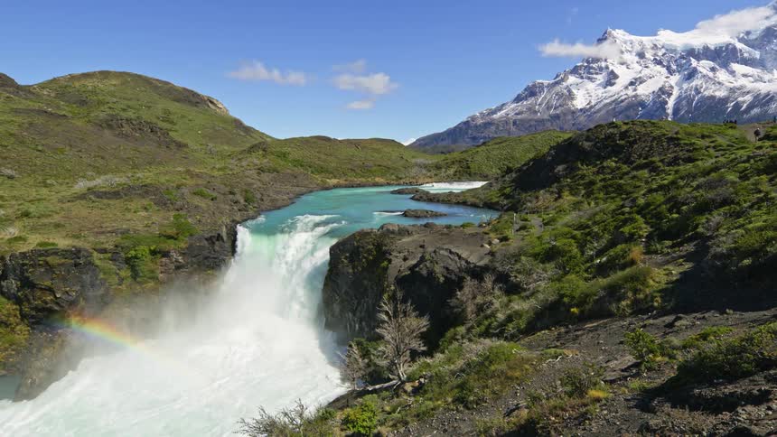 A river that collapses into a small waterfall in a mountainous region