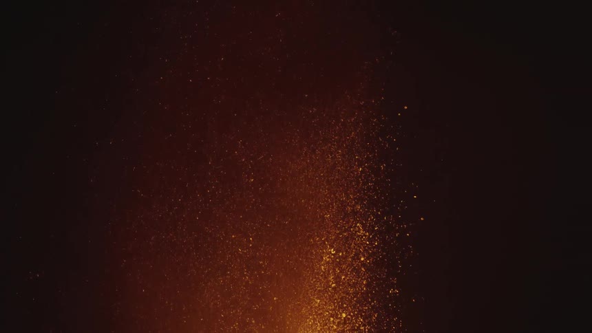 A volcanic eruption with bright lava and ash against a dark background