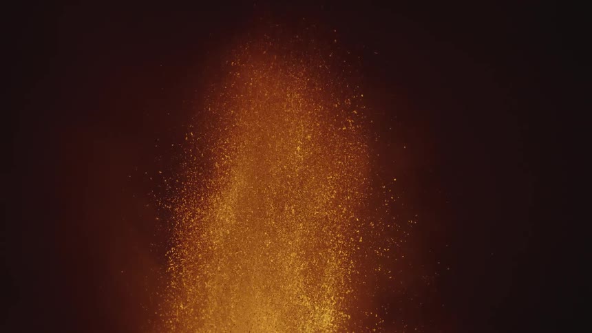 Hot glowing lava sprays into the air as a volcano erupts