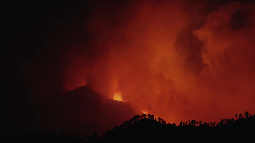 A volcano releases lava and large amounts of smoke