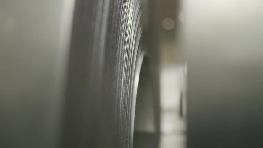 Close up of two rolls of thin metal sheet in a warehouse