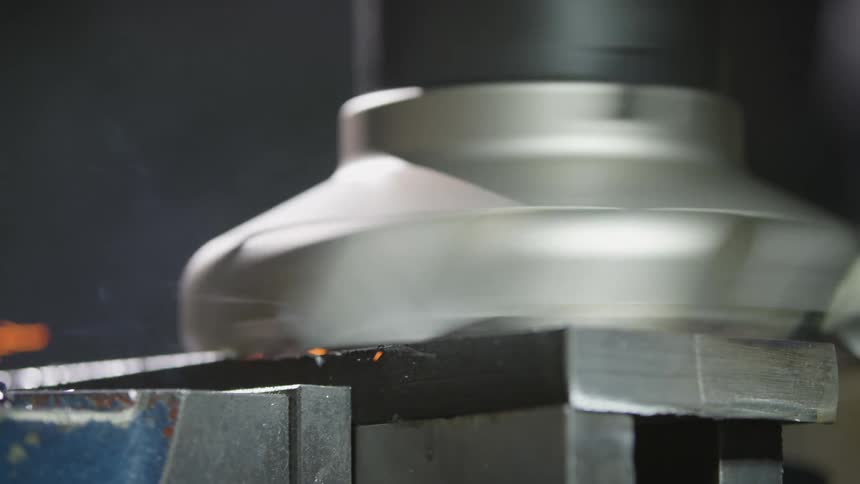 A metal machine spinning in a factory