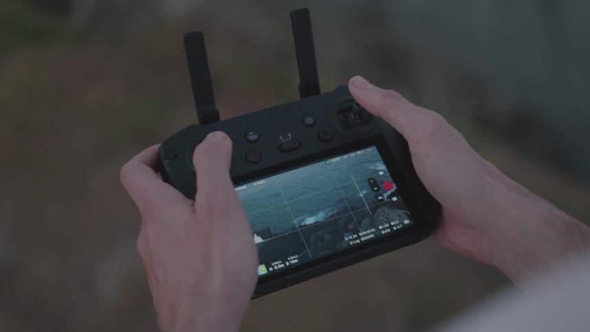 A person controlling a drone via a portable screen on a device