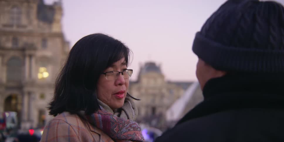 Portrait of an asian couple talking to each other in a public square