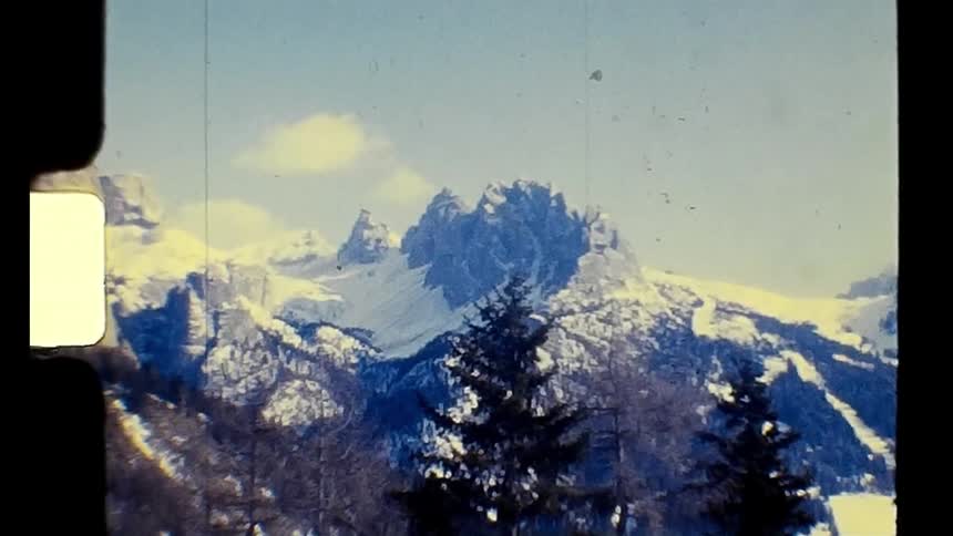 A mountain range is filled with jagged peaks covered in snow
