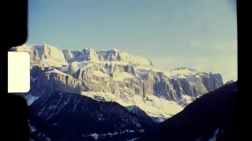 A ski resort sits amid a large mountain range