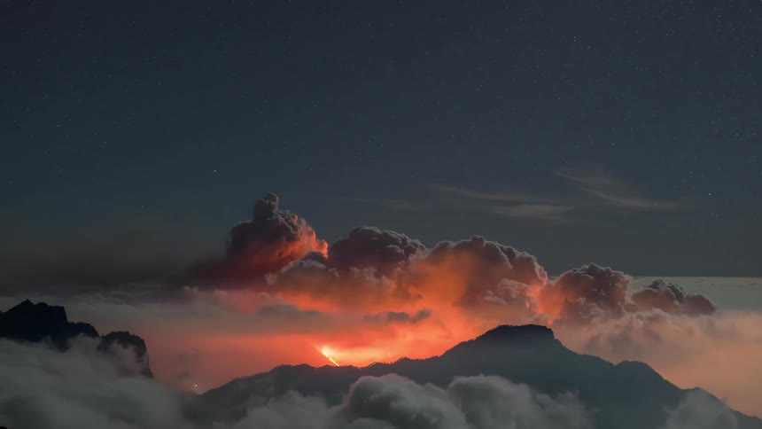 Aerial of an erupting volcano at dusk
