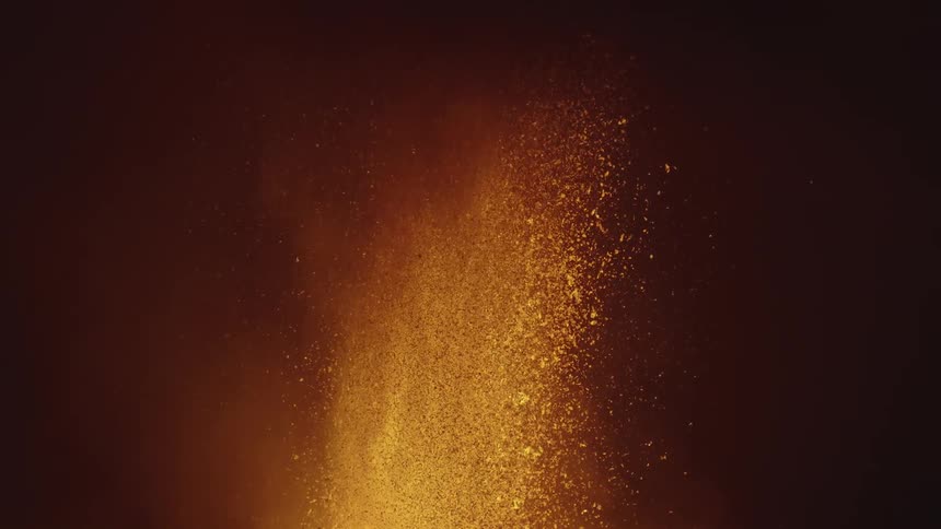 Volcano erupting as hot glowing lava sprays into the night sky
