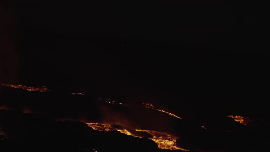 A lot of lava flowing down a hill at night