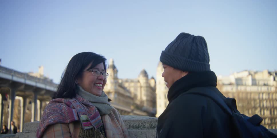 A man and woman talk in the city