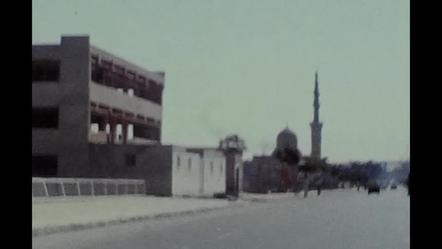 A building and mosque sit near a busy street