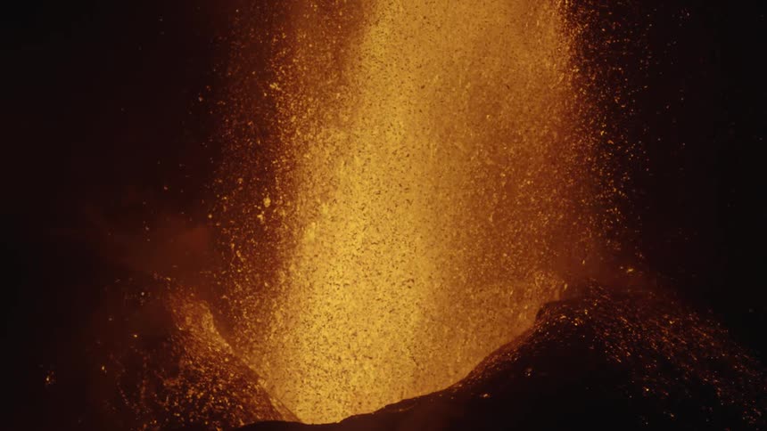 An erupting volcano blasting lava upward
