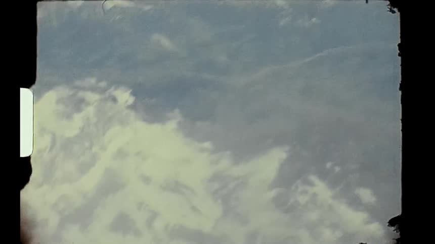 The plane is flying high in the clouds