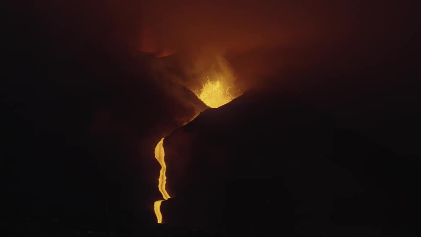 A rift and a mountain with an erupting volcano spewing lava upwards