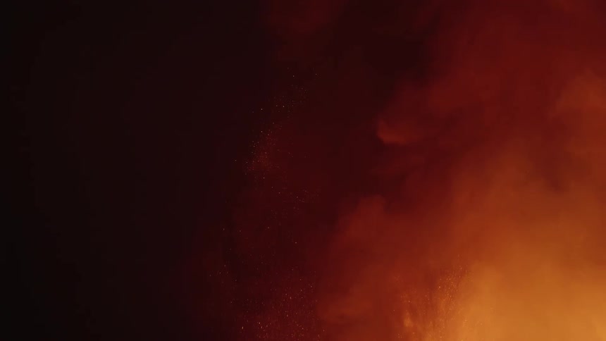 A volcano is erupting at night