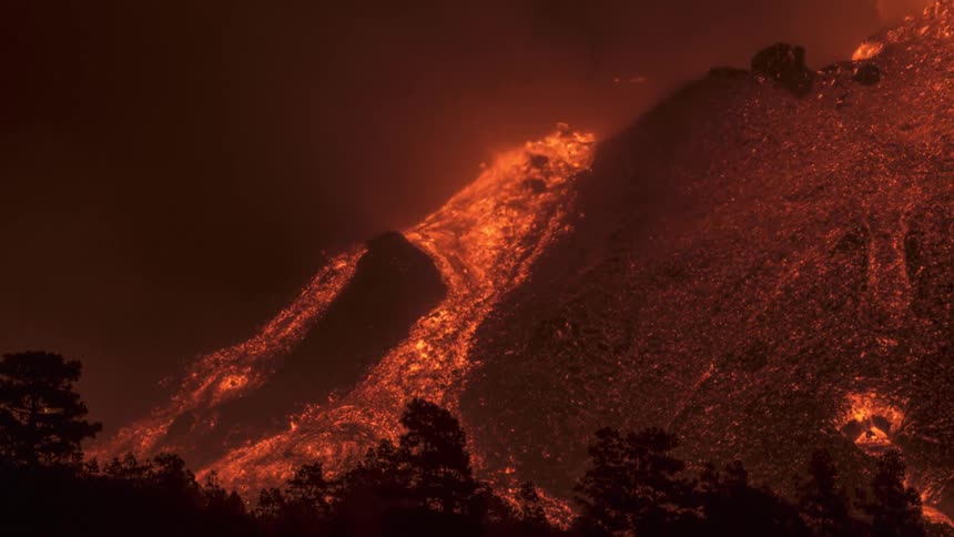 Time lapse of lava flowing down the slope of a mountain during a volcanic eruption