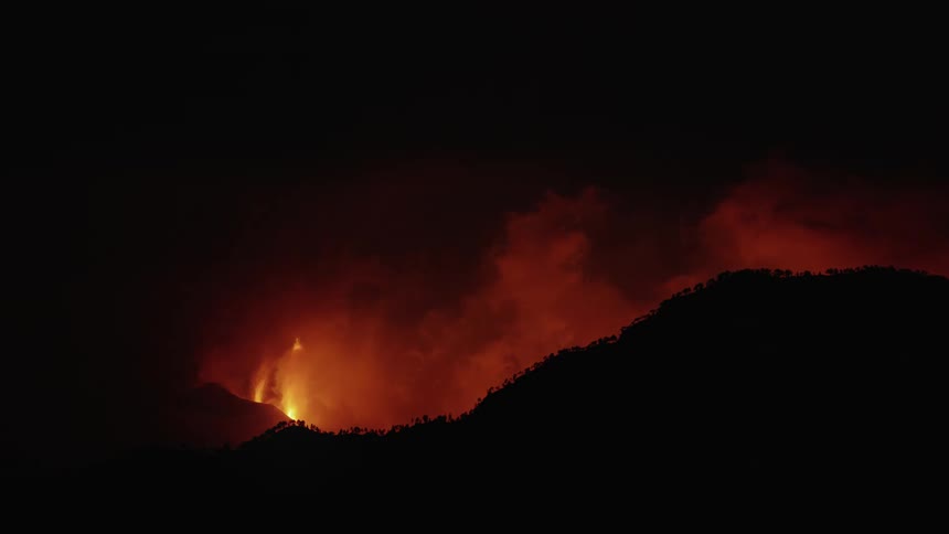 Lava and flames emerge from a volcanic eruption
