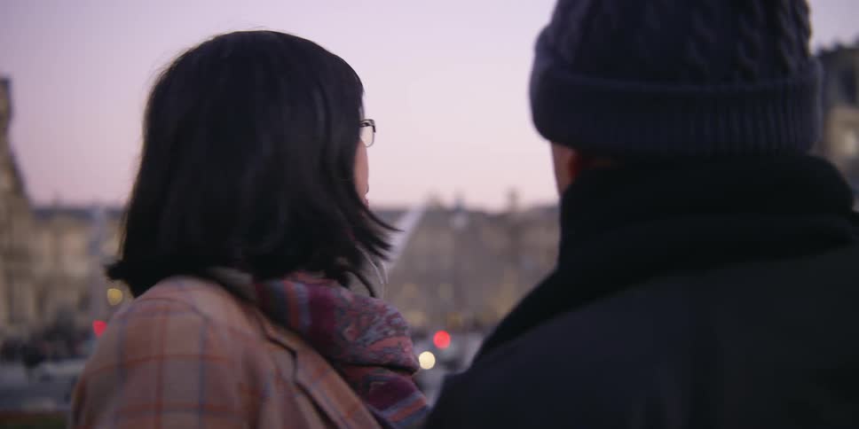 Closeup of a couple talking in the center of a big city