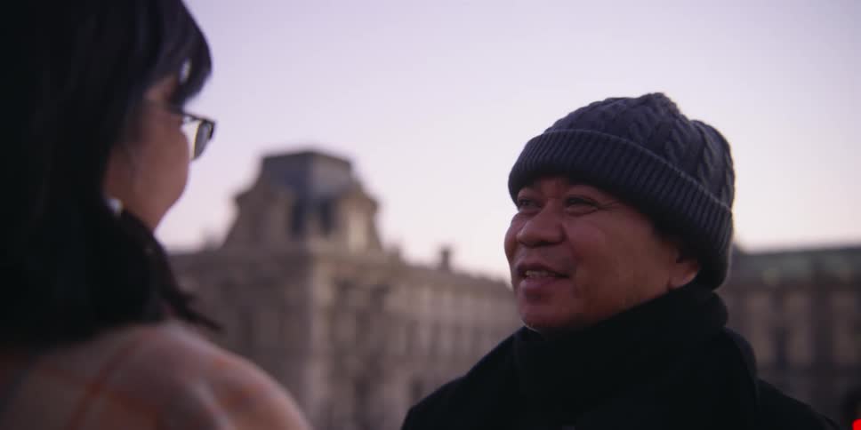 Portrait of a man talking to a woman outdoors
