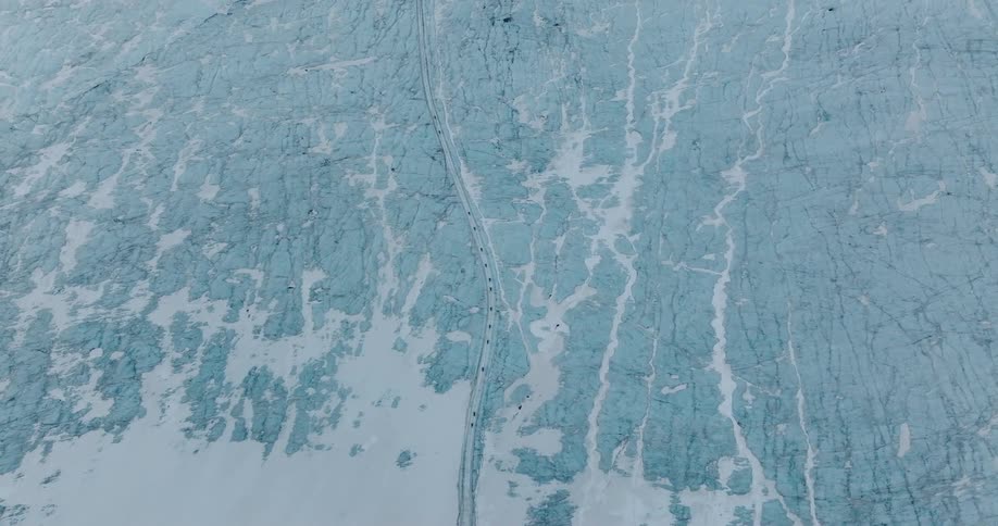 Vehicles travel on the icy road
