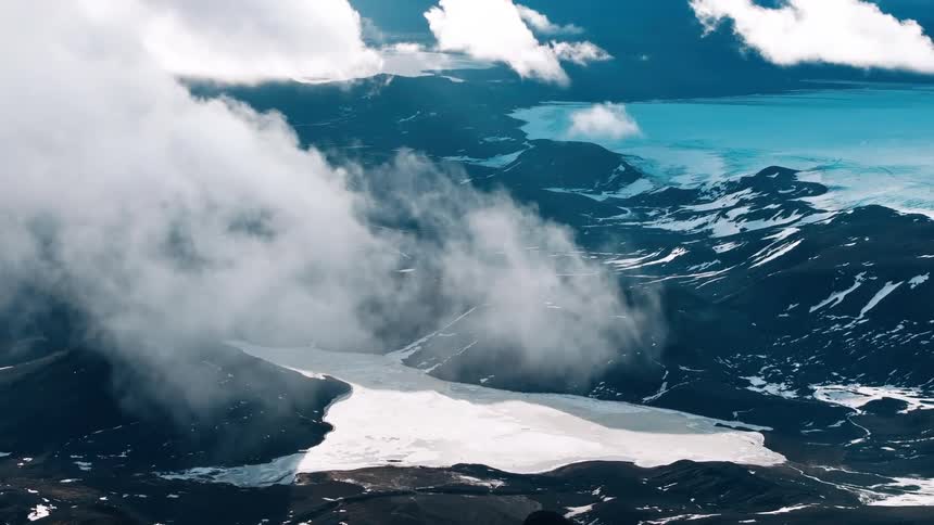 Wispy clouds move over a coastal mountain region