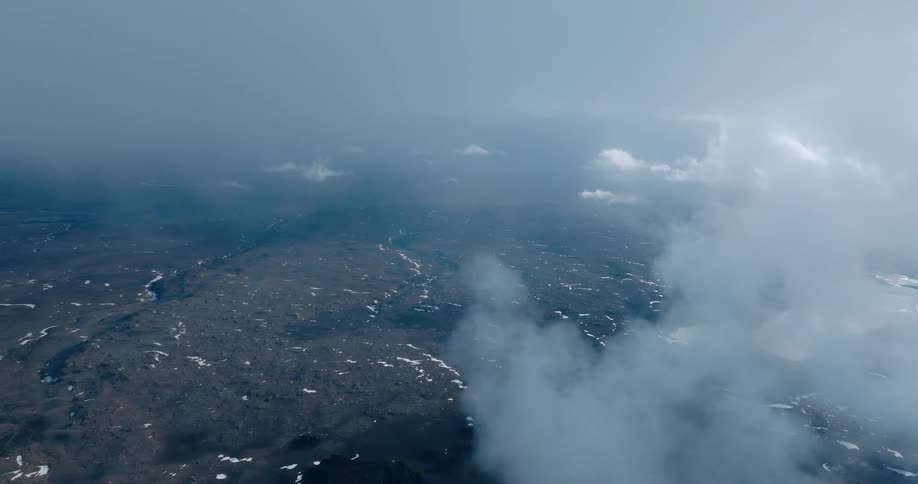 Aerial panorama at cloud level with mountains and snow
