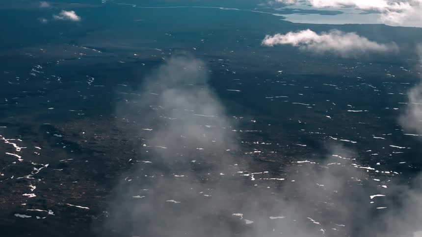 Aerial landscape with snow trails on a peninsula with sea