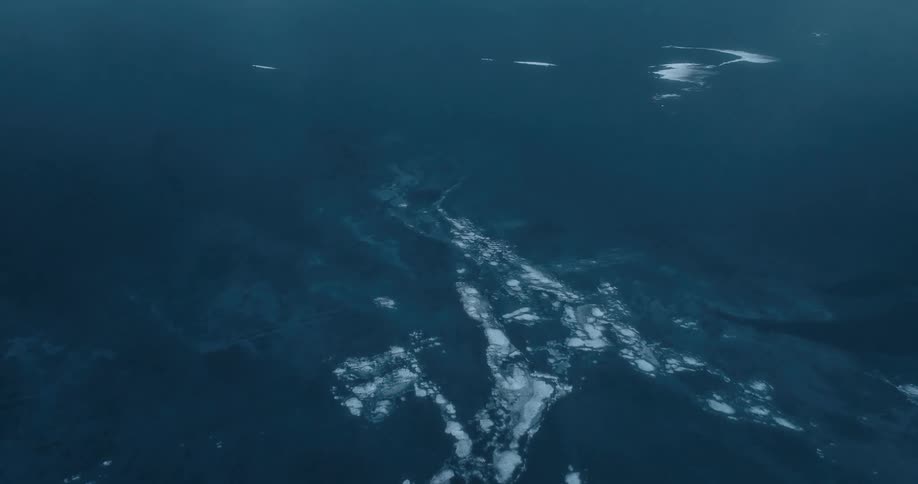 Aerial of polar ice caps melting into the ocean