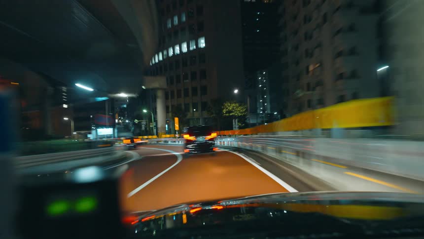 Taxi driving on a highway in the city at night