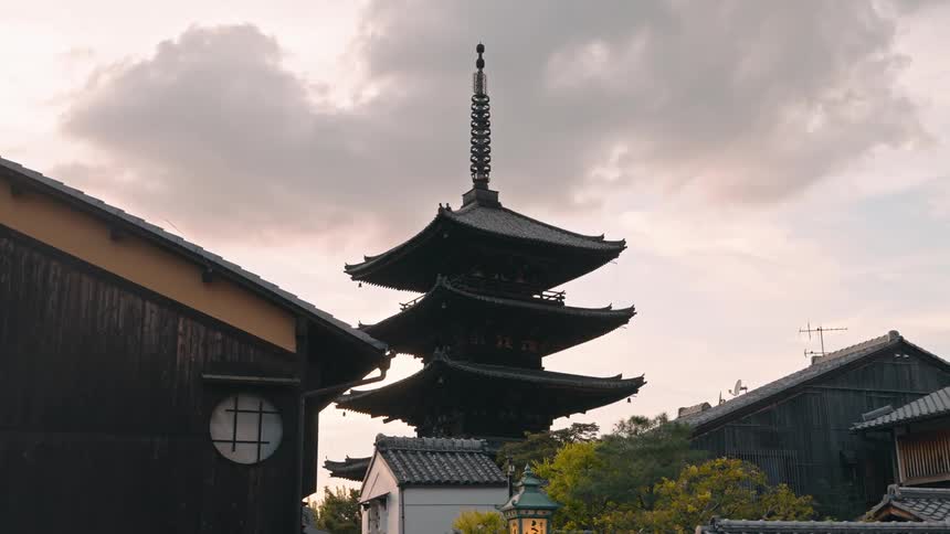 Tall dark pagoda in a small japanese town at evening