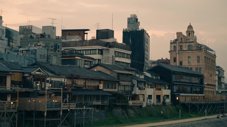 Traditional and modern buildings by a river in Kyoto
