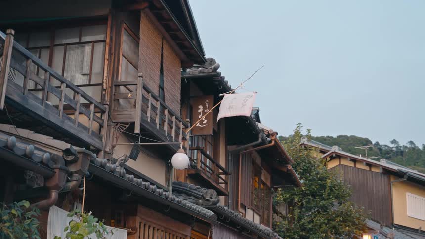 A small flag hanging from a house bounces in the wind