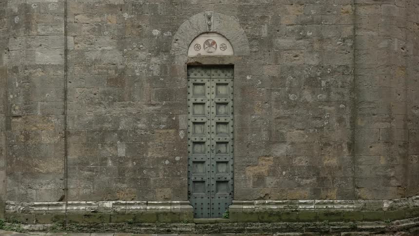 Tall skinny door  on an old stone building