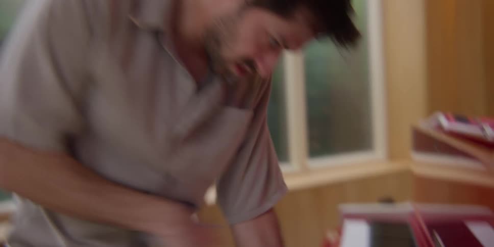 A man cleaning and playing piano while dancing indoor at midday