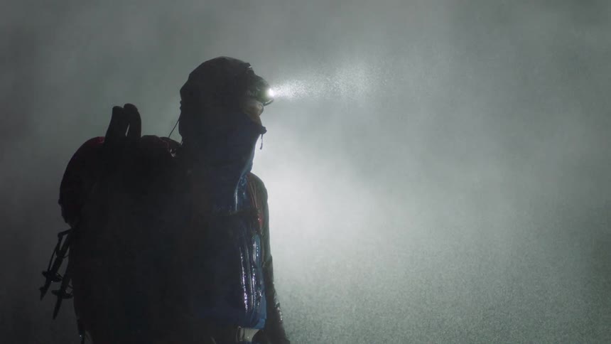 A man is walking in the pouring rain