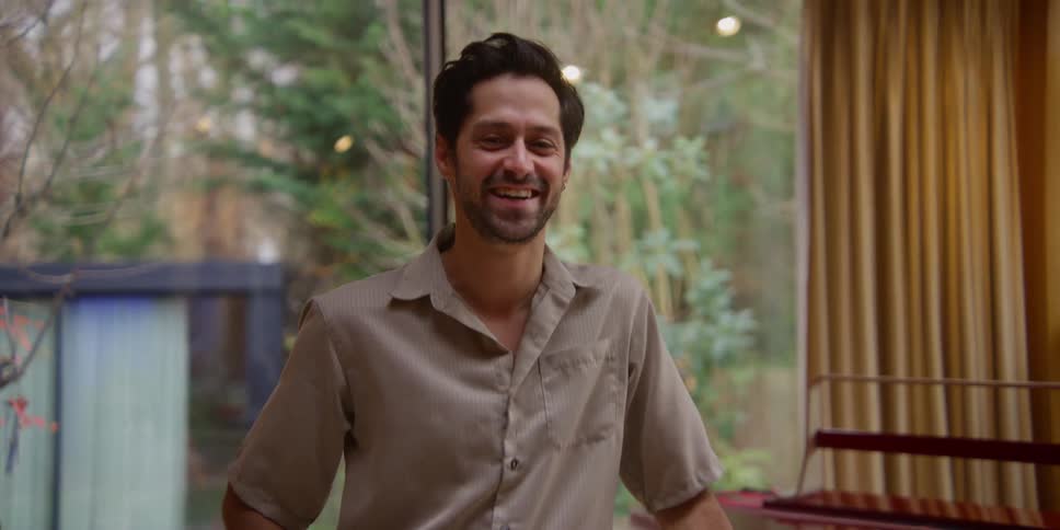 A man is laughing at home