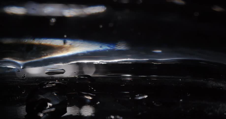 The surface of a black object with some broken parts
