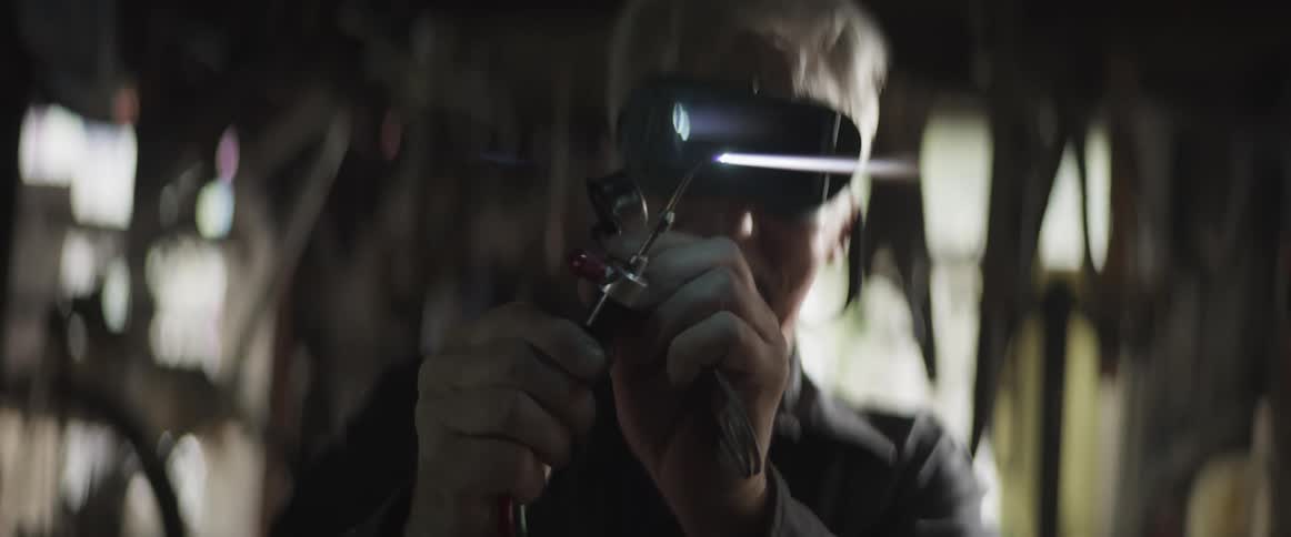 A man with goggles is adjusting the intensity of a blowtorch and it starts to breathe fire