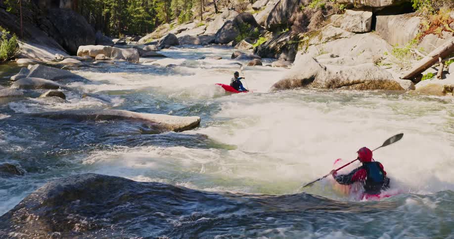 People on a river in canoes during the day