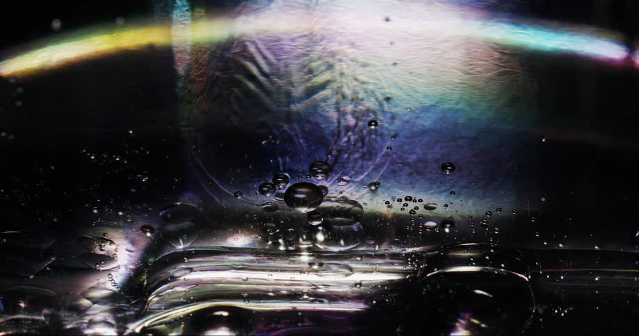 Multicolored light arcs through colorful bubble filled liquid