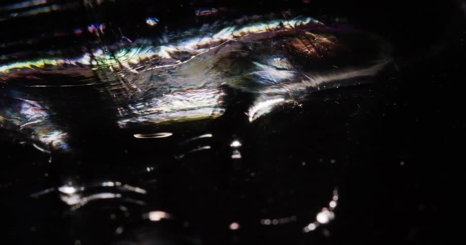 Texture of a dense shiny liquid in abstract movement and slow motion