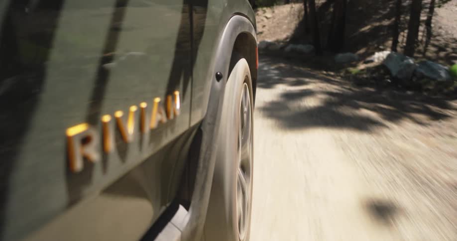 Wheels of a vehicle driving on a dirt road in the forest