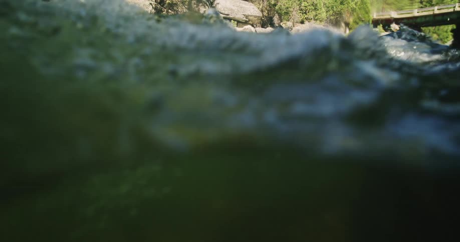 Closeup of running water in moving river during the day